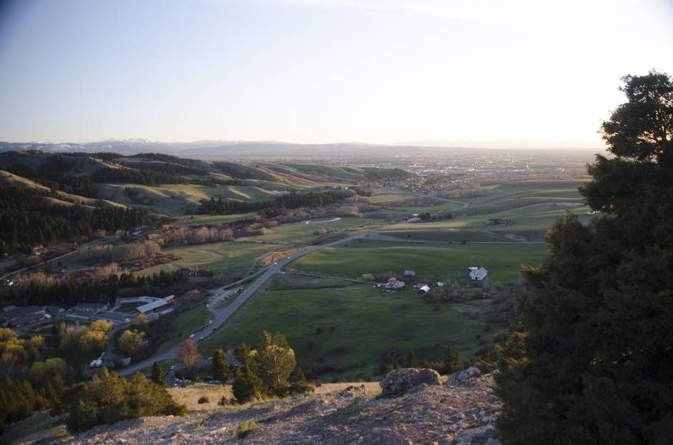 Evening view of Gallatin Valley with trailhead parking lot below
