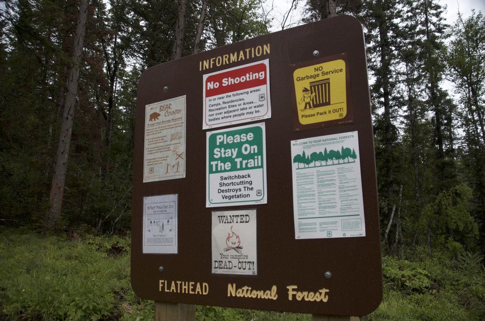 Flathead National Forest information board with trail rules and warnings