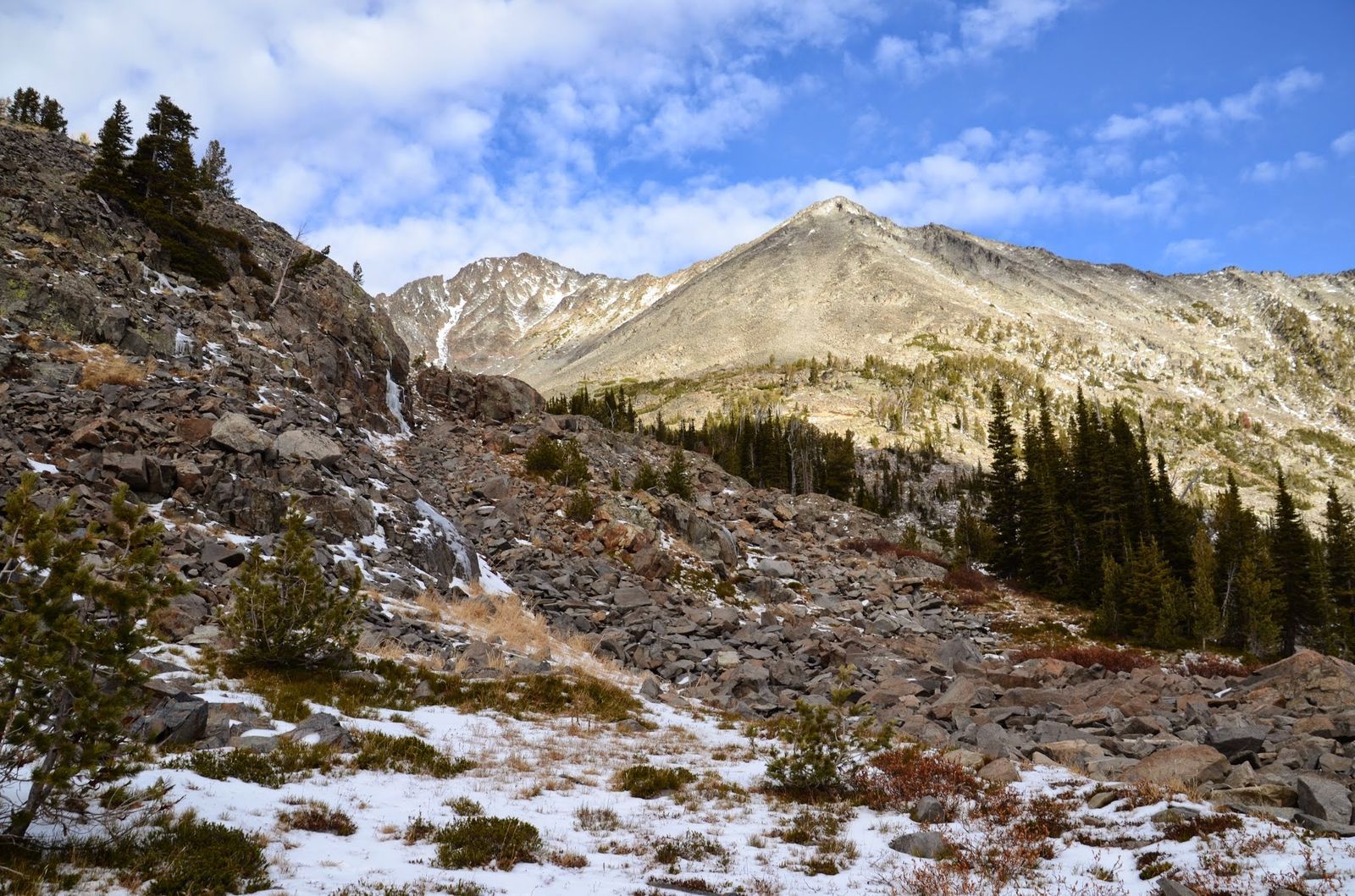 Talus field and rocky slopes with prominent Crazy Mountain summit