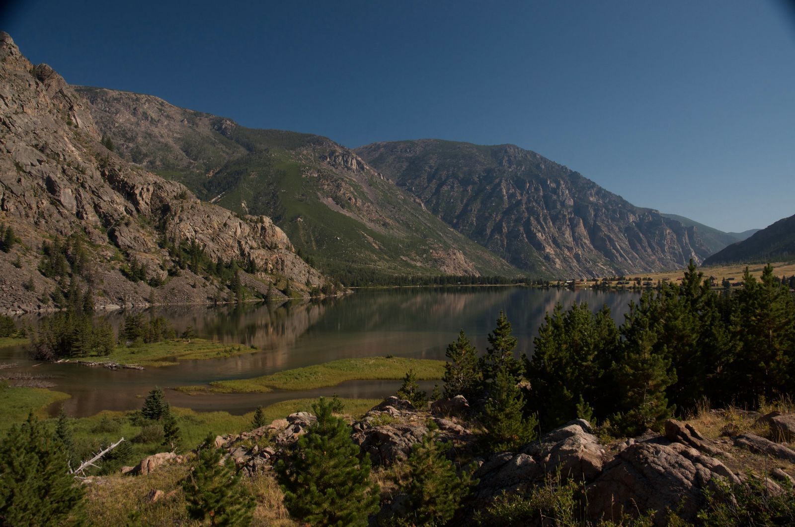 East Rosebud Lake with massive granite cliffs rising from calm waters