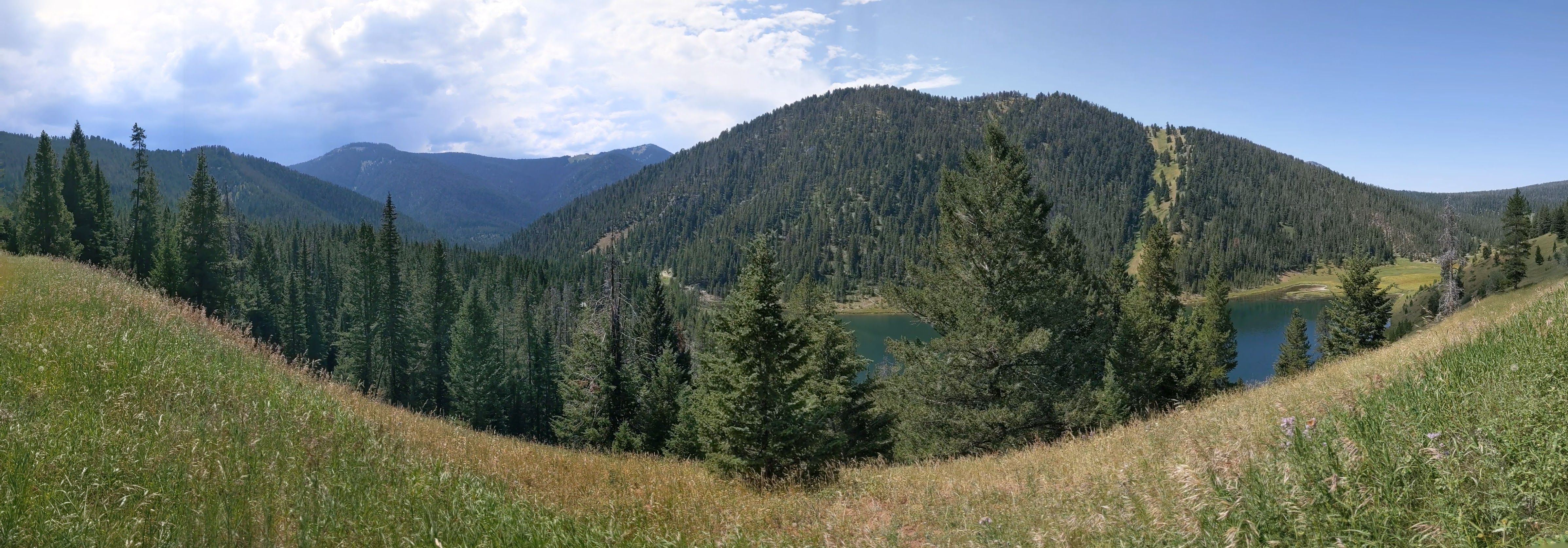 Panoramic view of Mystic Lake basin with forested mountains