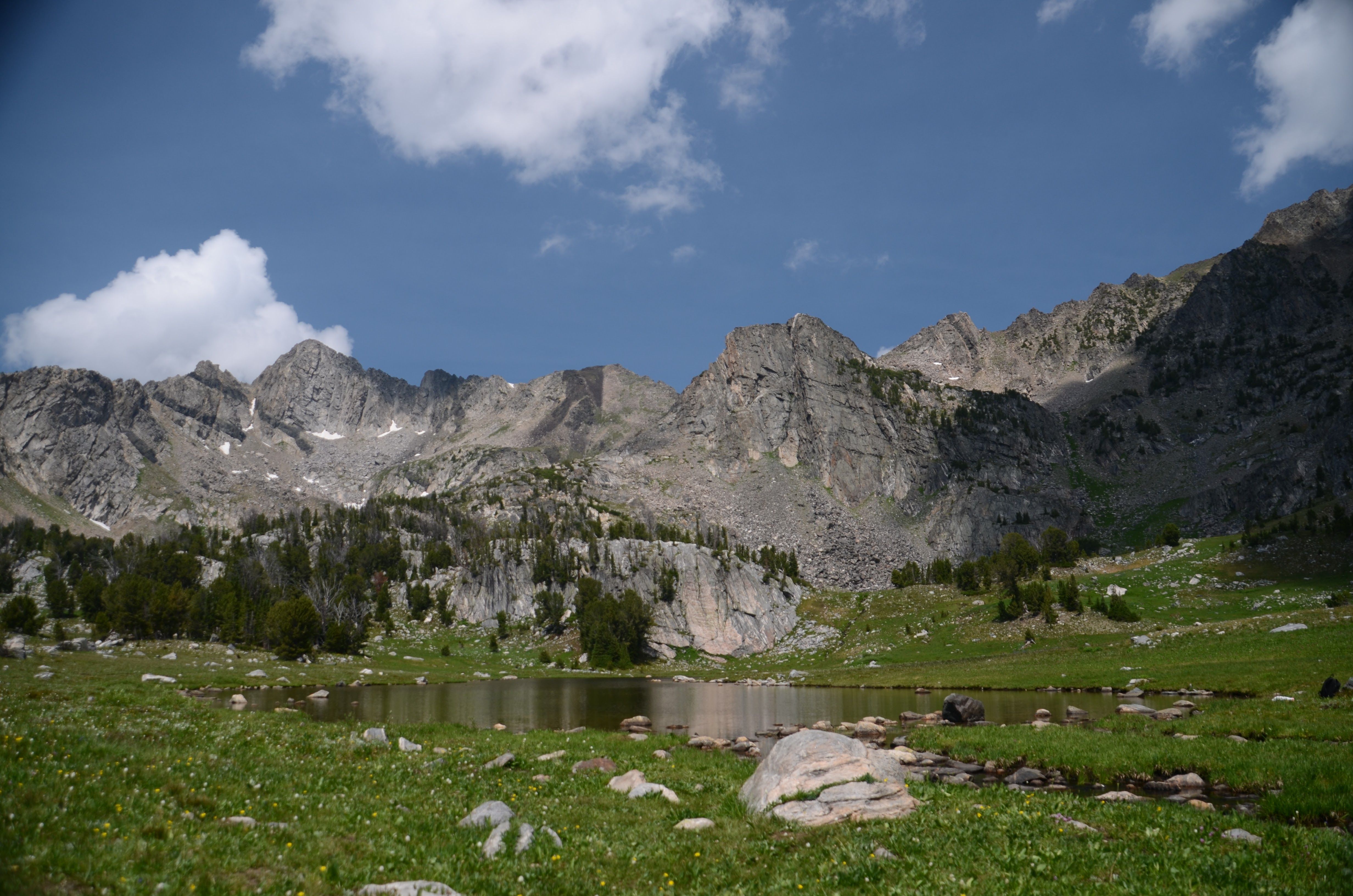 Alpine lake at Beehive Basin surrounded by dramatic mountain peaks
