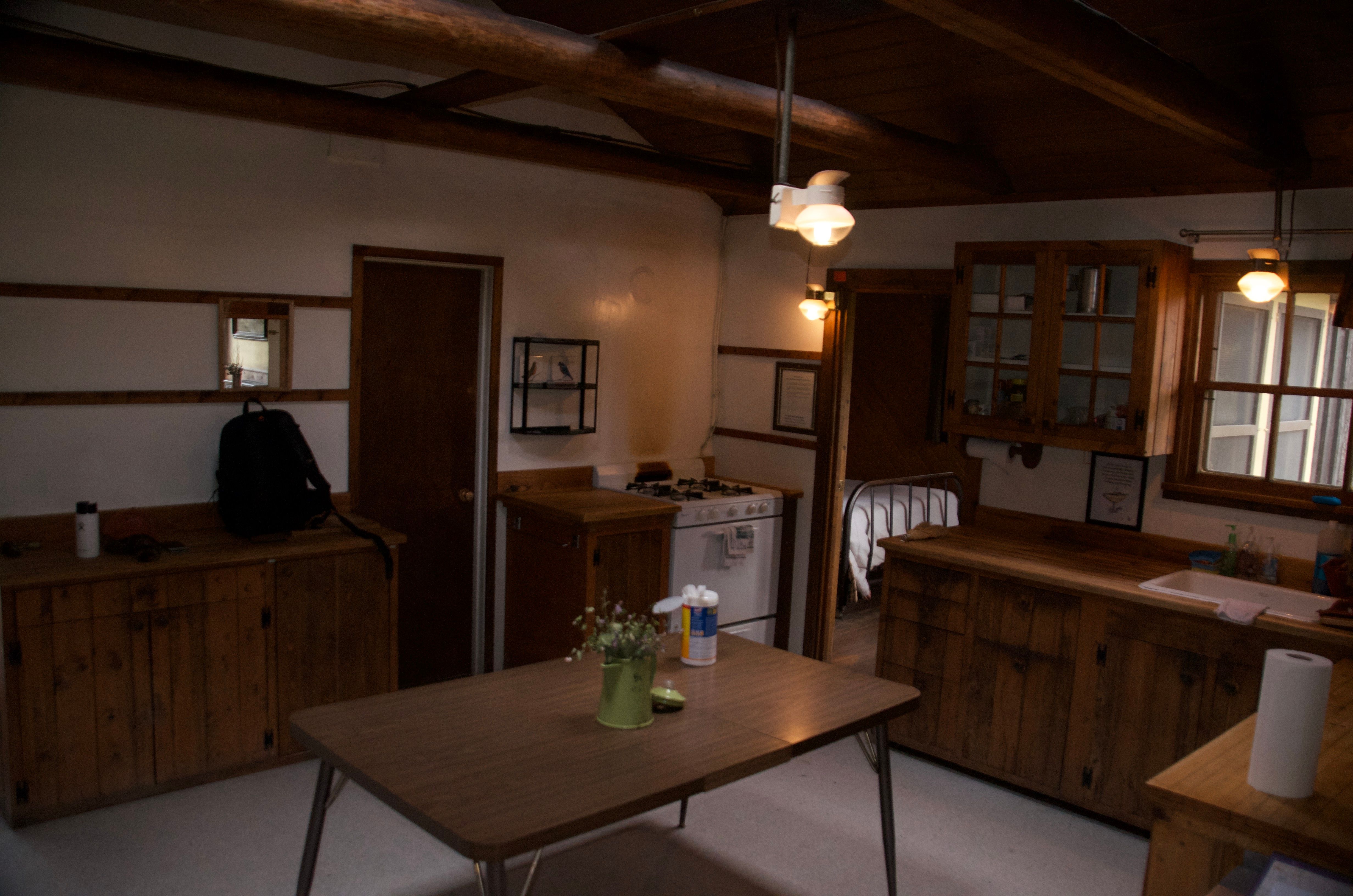 Ben Rover Cabin kitchen with gas stove and wood cabinets