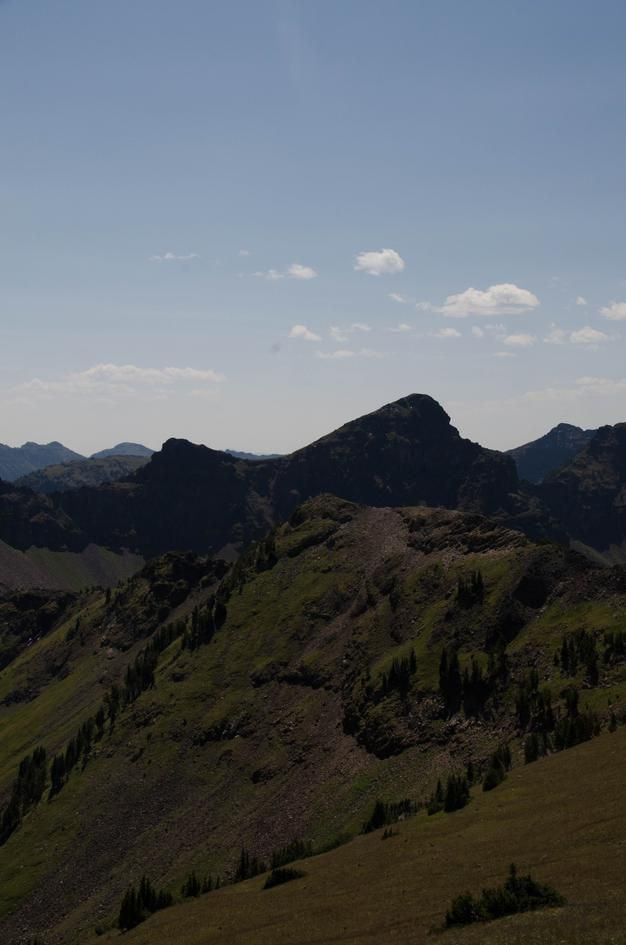 Rugged Hyalite peaks with steep grassy slopes and rocky summits