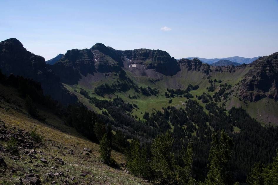 Alpine cirque with snow patches surrounded by towering peaks