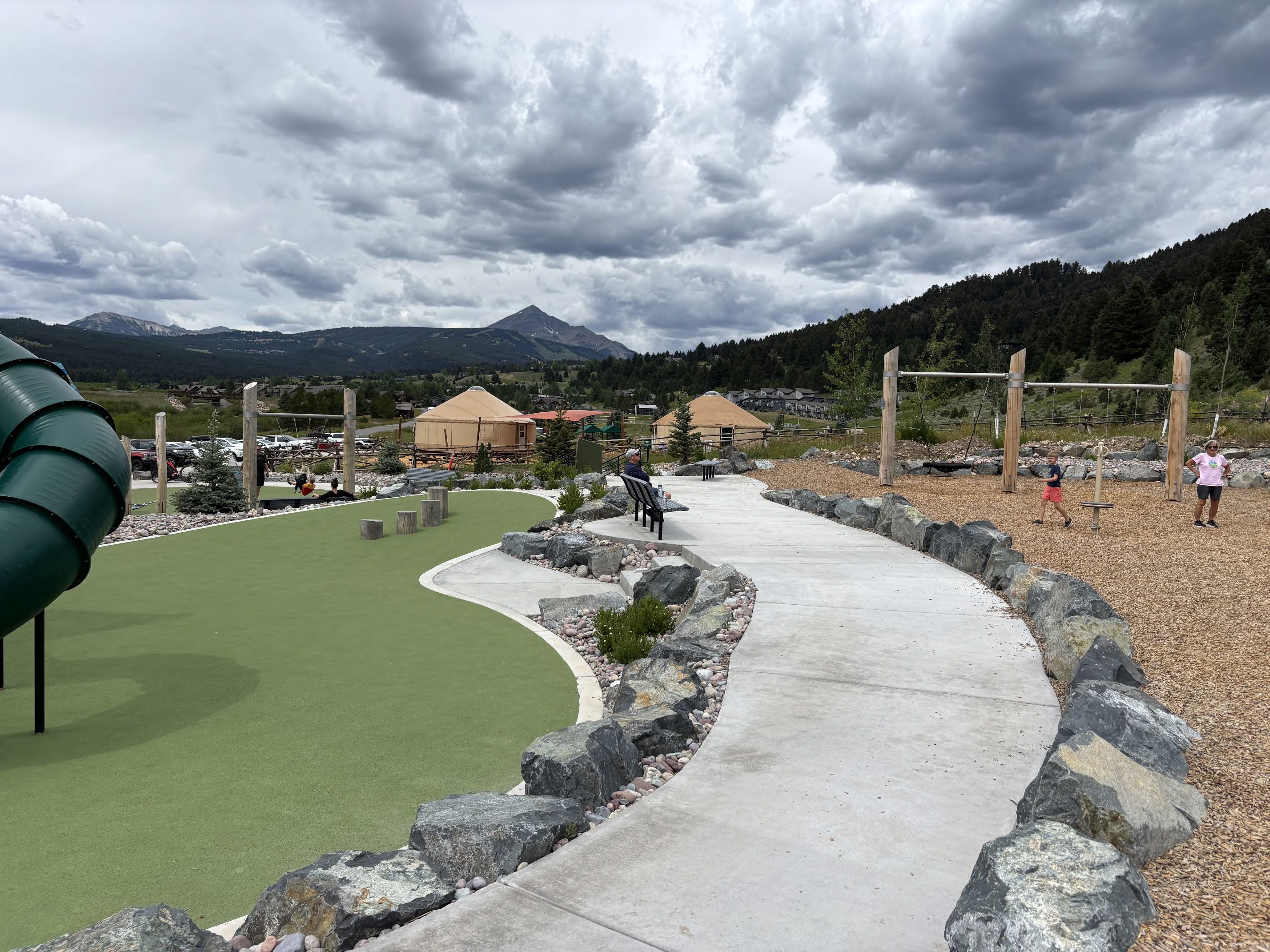 Big Sky Community Park timber playground with climbing towers and mountain views