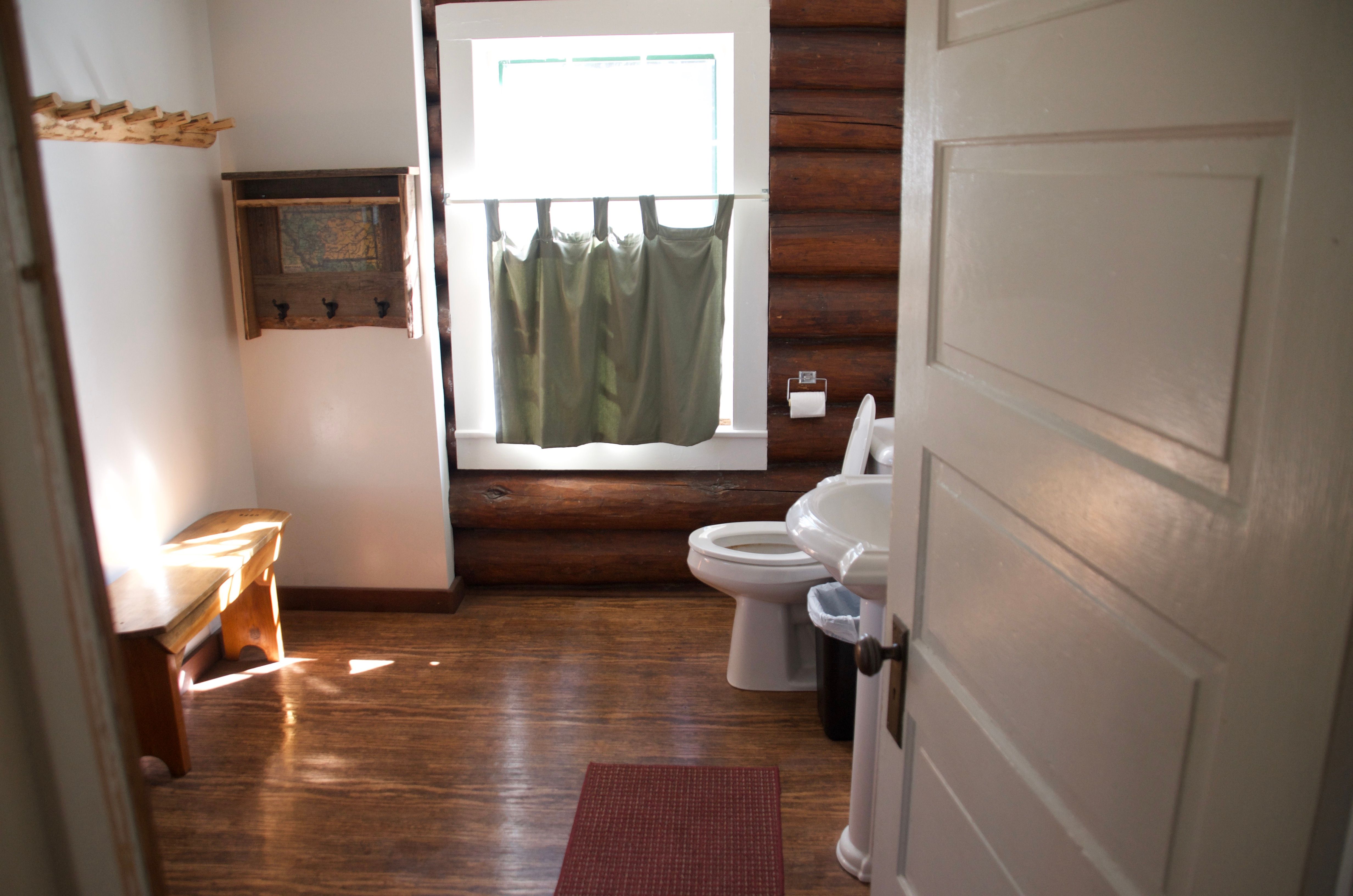 The main floor bathroom at the Old Condon Ranger Station with a toilet and sink