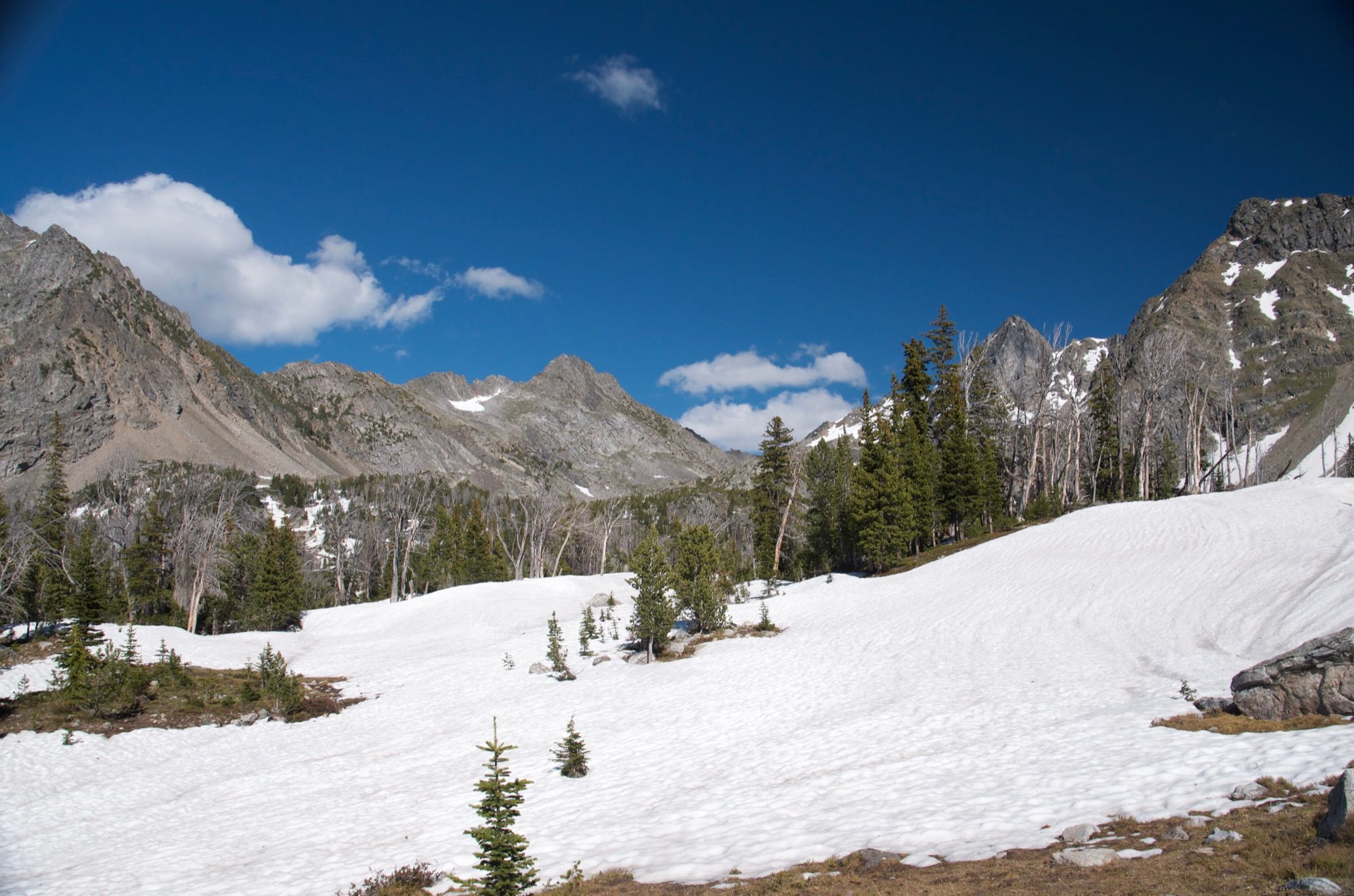 Snow-covered high basin with jagged Spanish Peaks rising in the background
