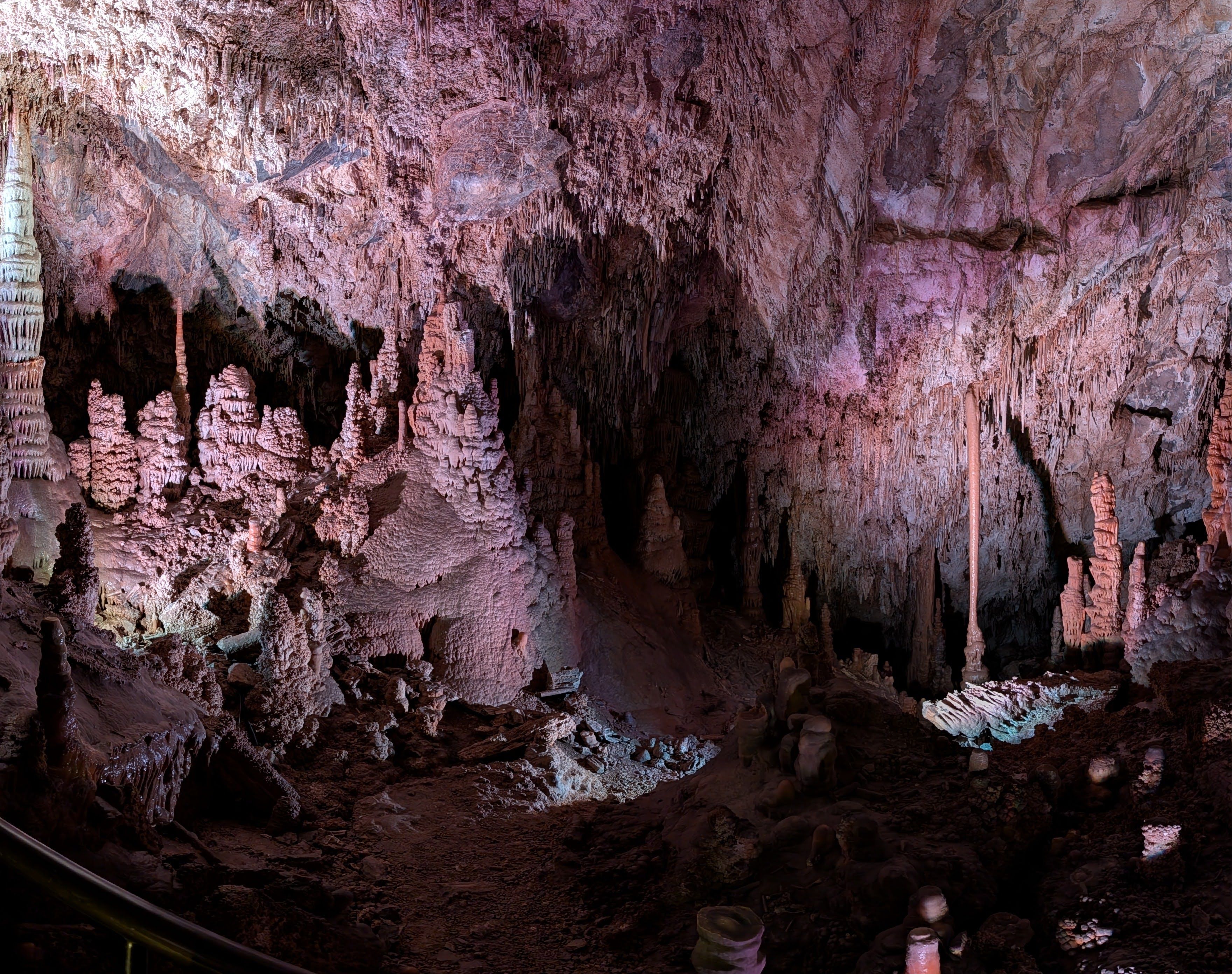 Panoramic view of large cave chamber with formations