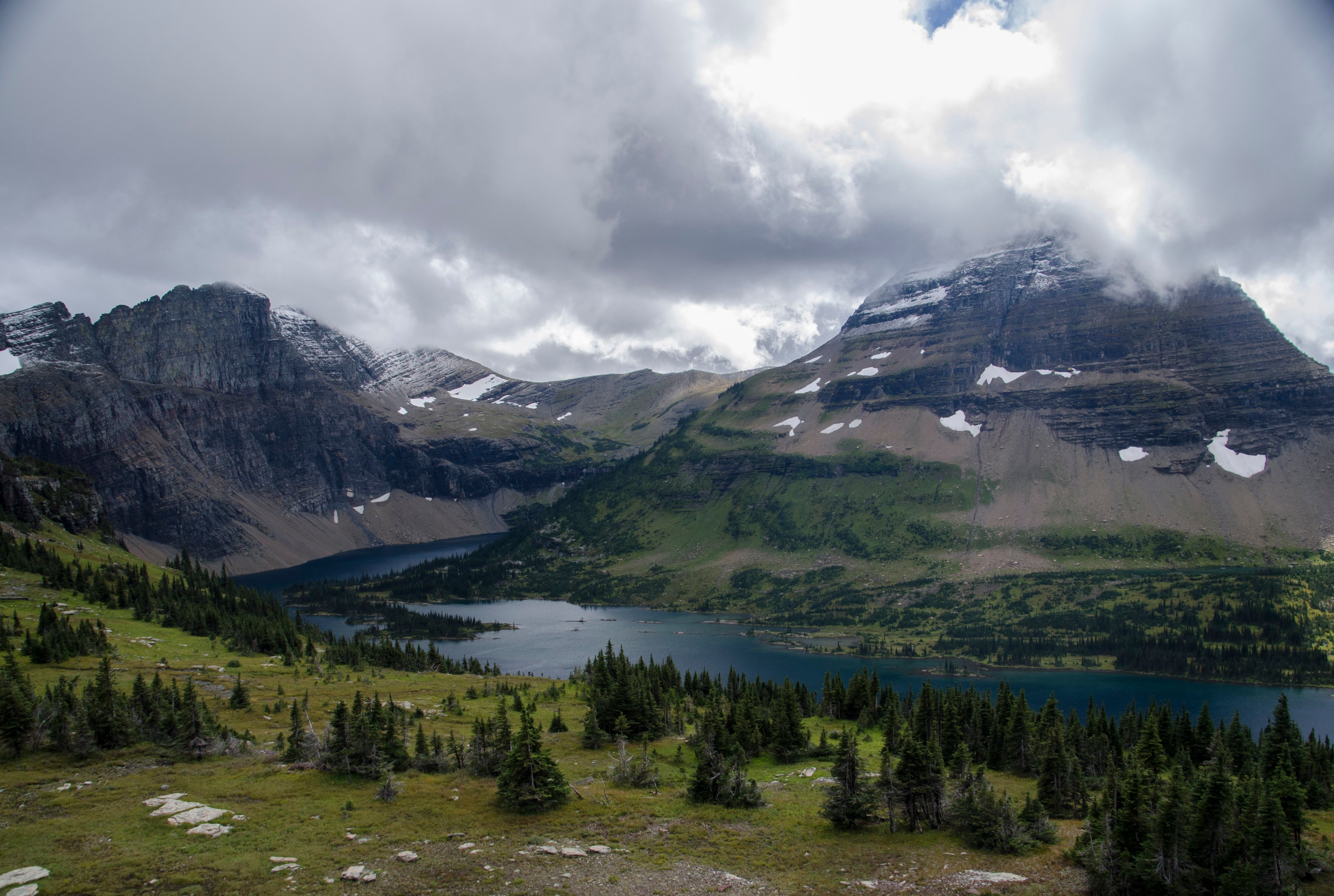 Hidden Lake below Bearhat Mountain with snow patches and dramatic cloud cover