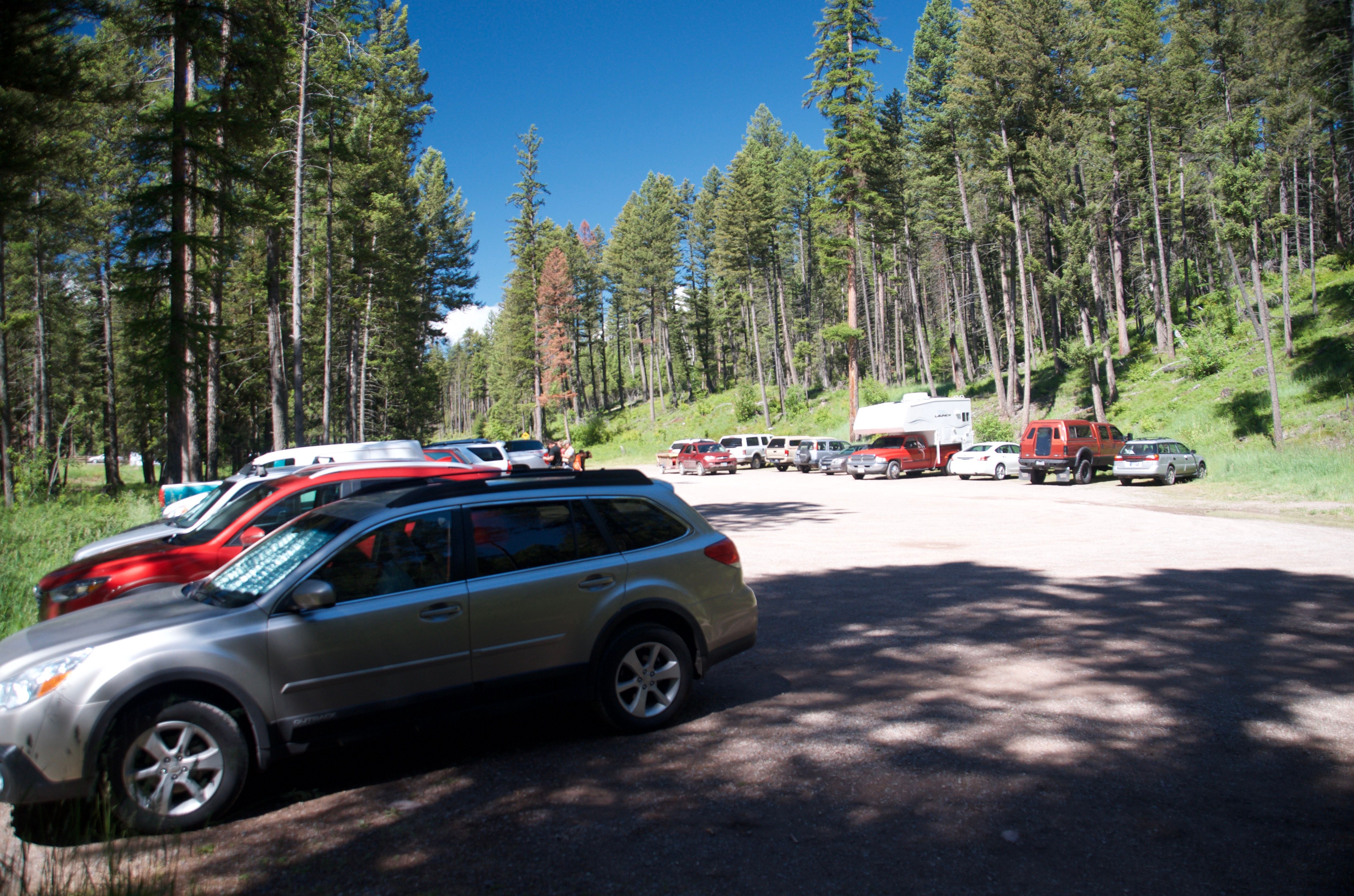 Holland Falls trailhead parking lot packed with cars on a summer day