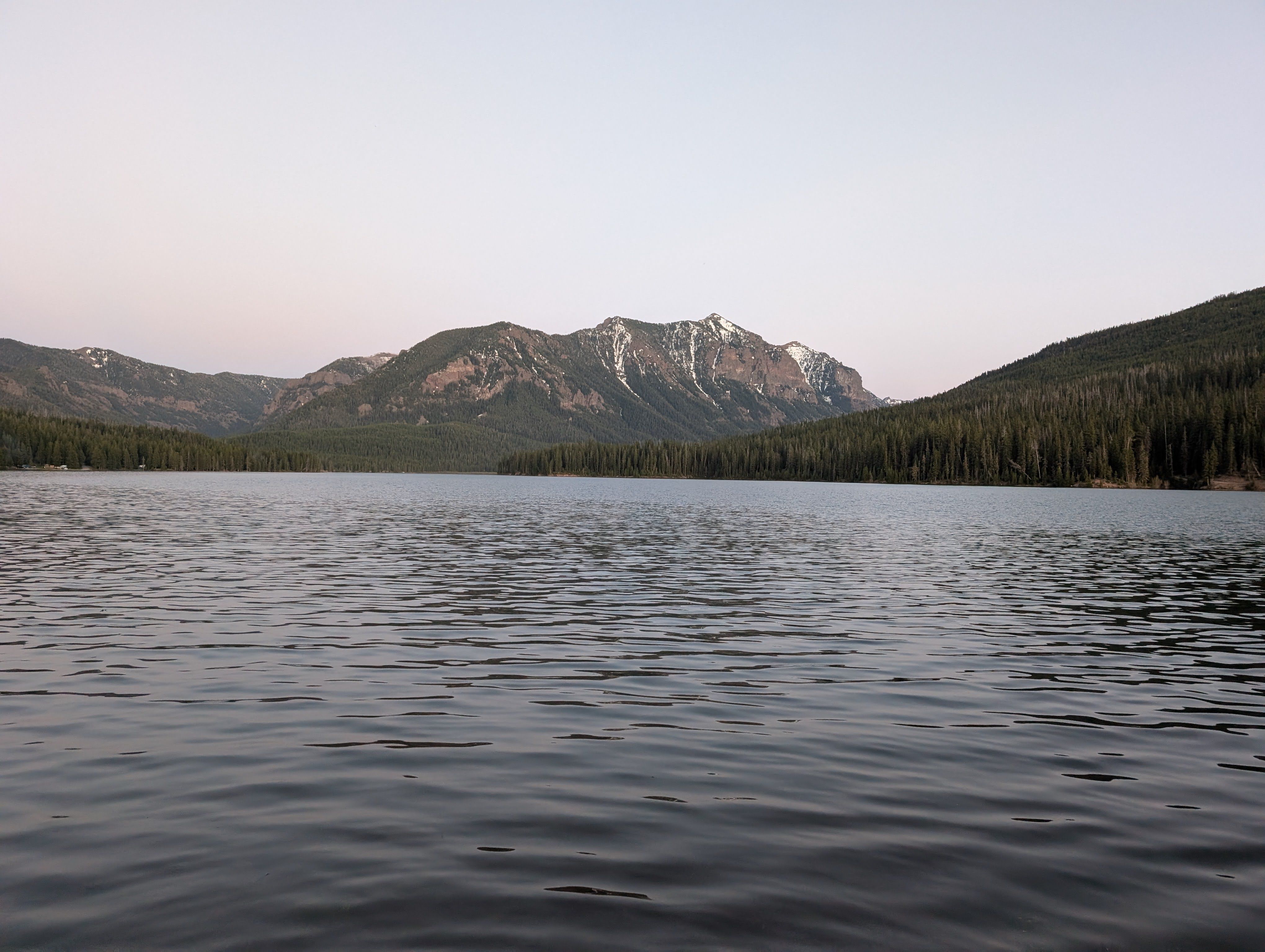 View of Hyalite Reservoir and surrounding mountains from a boat on the water