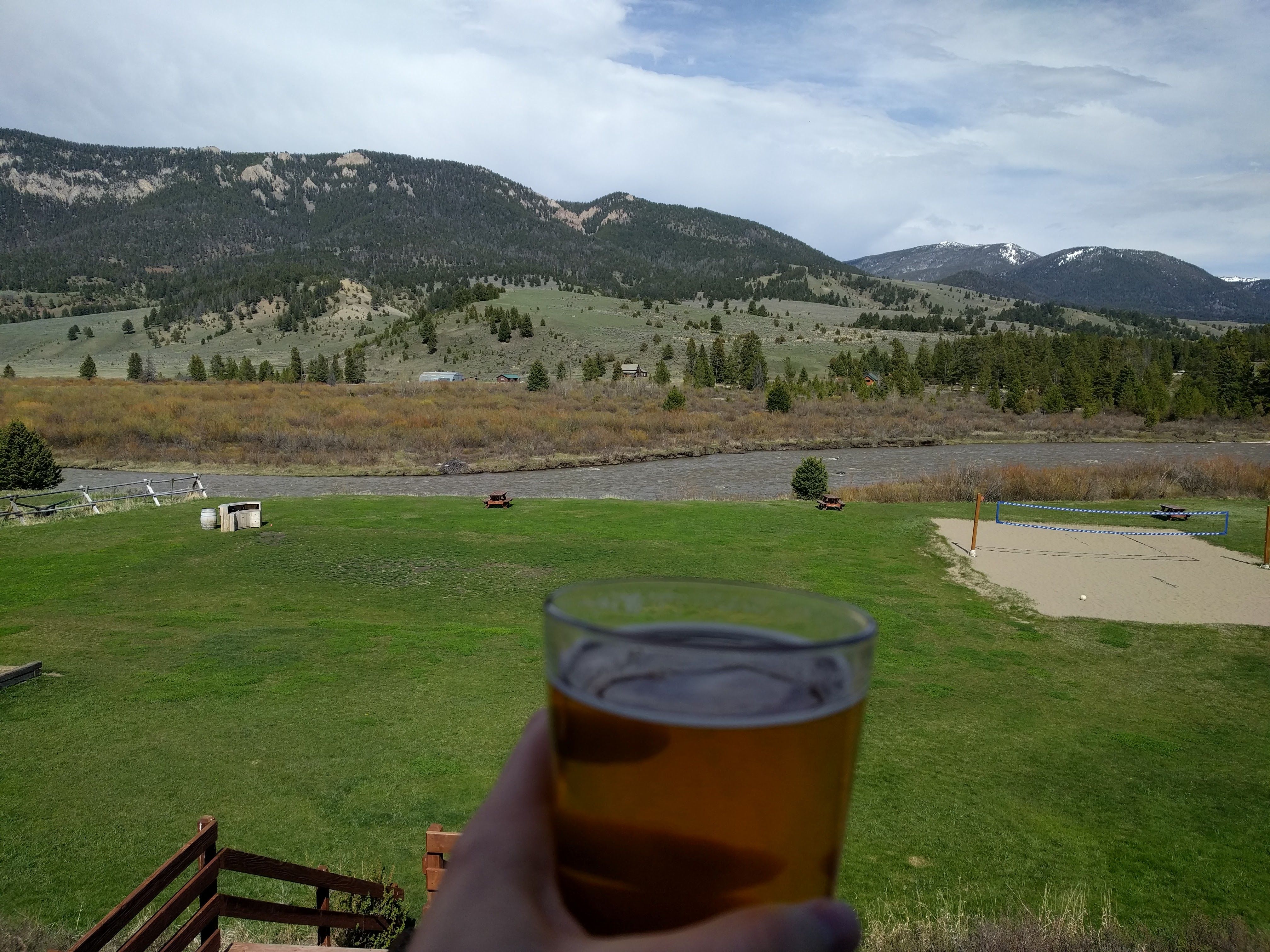 Cold beer in hand overlooking the Gallatin River and mountains from Riverhouse BBQ