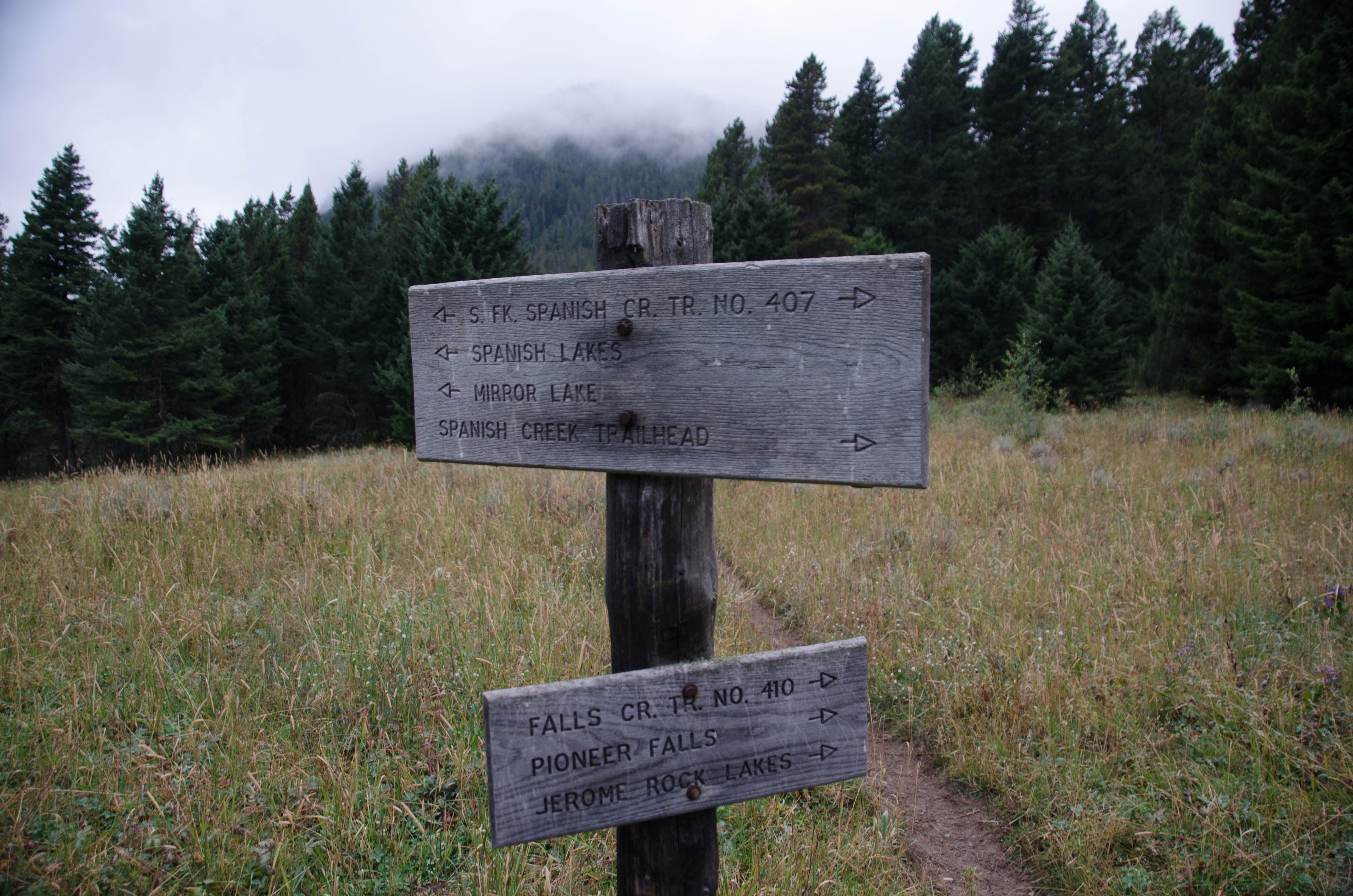 Wooden trail sign showing directions to Mirror Lake, Spanish Lakes and Jerome Rock Lakes