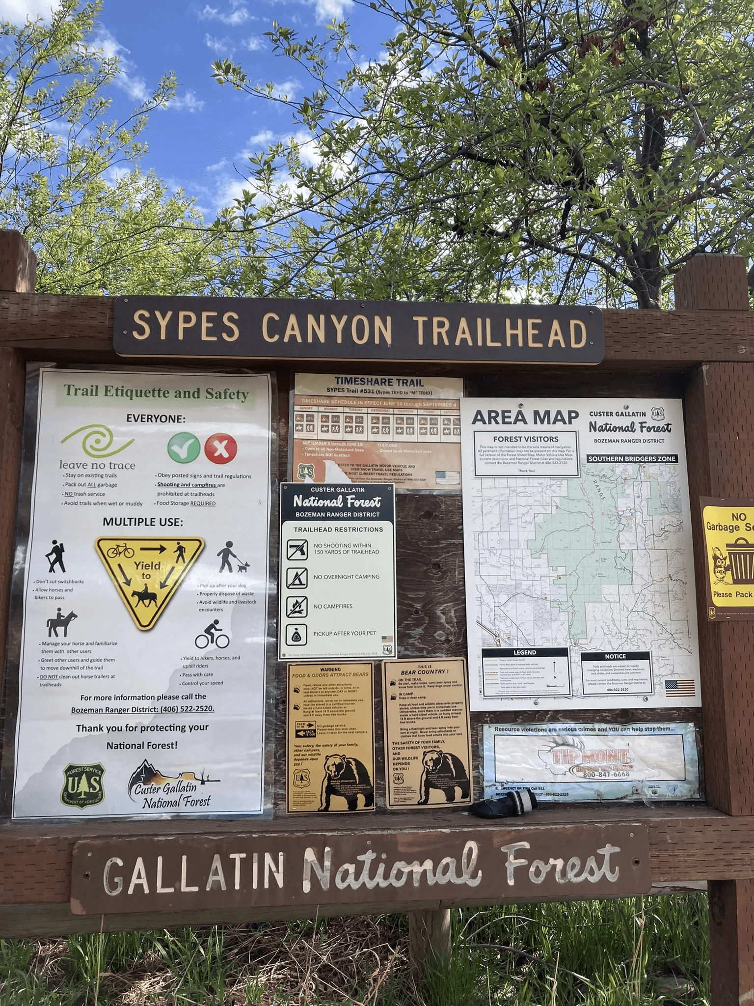 Sypes Canyon Trailhead kiosk with Forest Service map, etiquette signs, and bear country notices