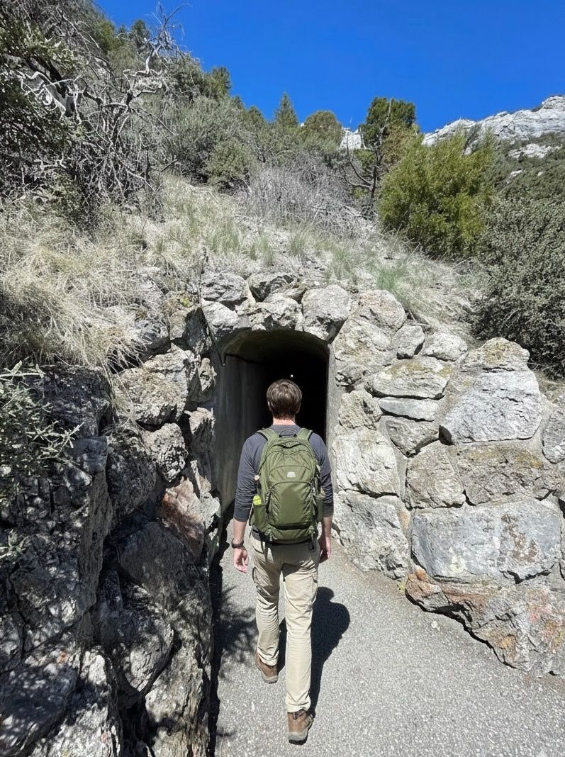 Hiker entering the cave tunnel