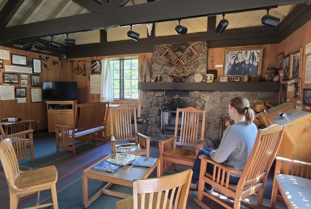 Visitor center interior with stone fireplace and wooden chairs