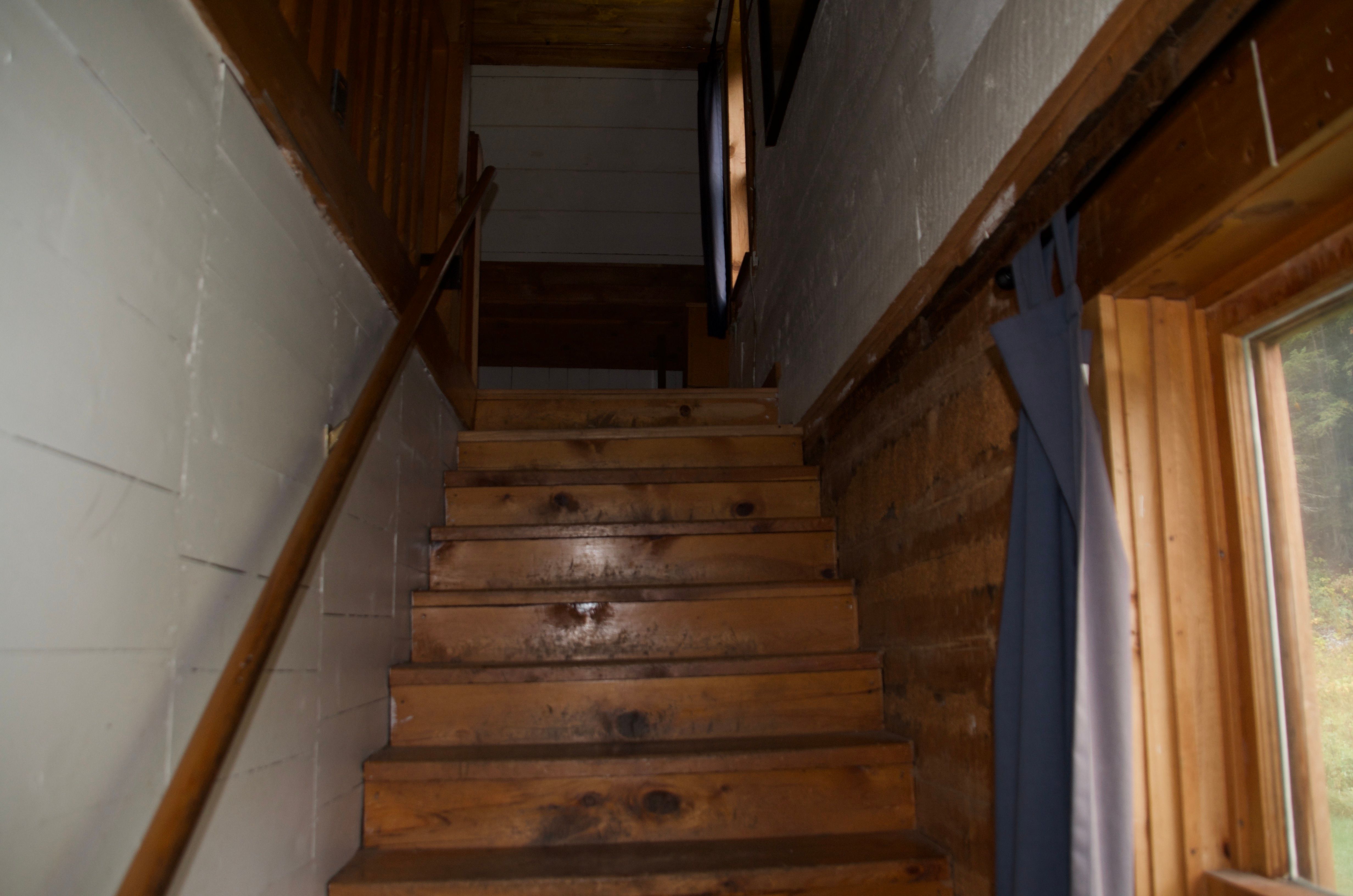 The steep wooden staircase leading to the upstairs sleeping loft at Wurtz Cabin