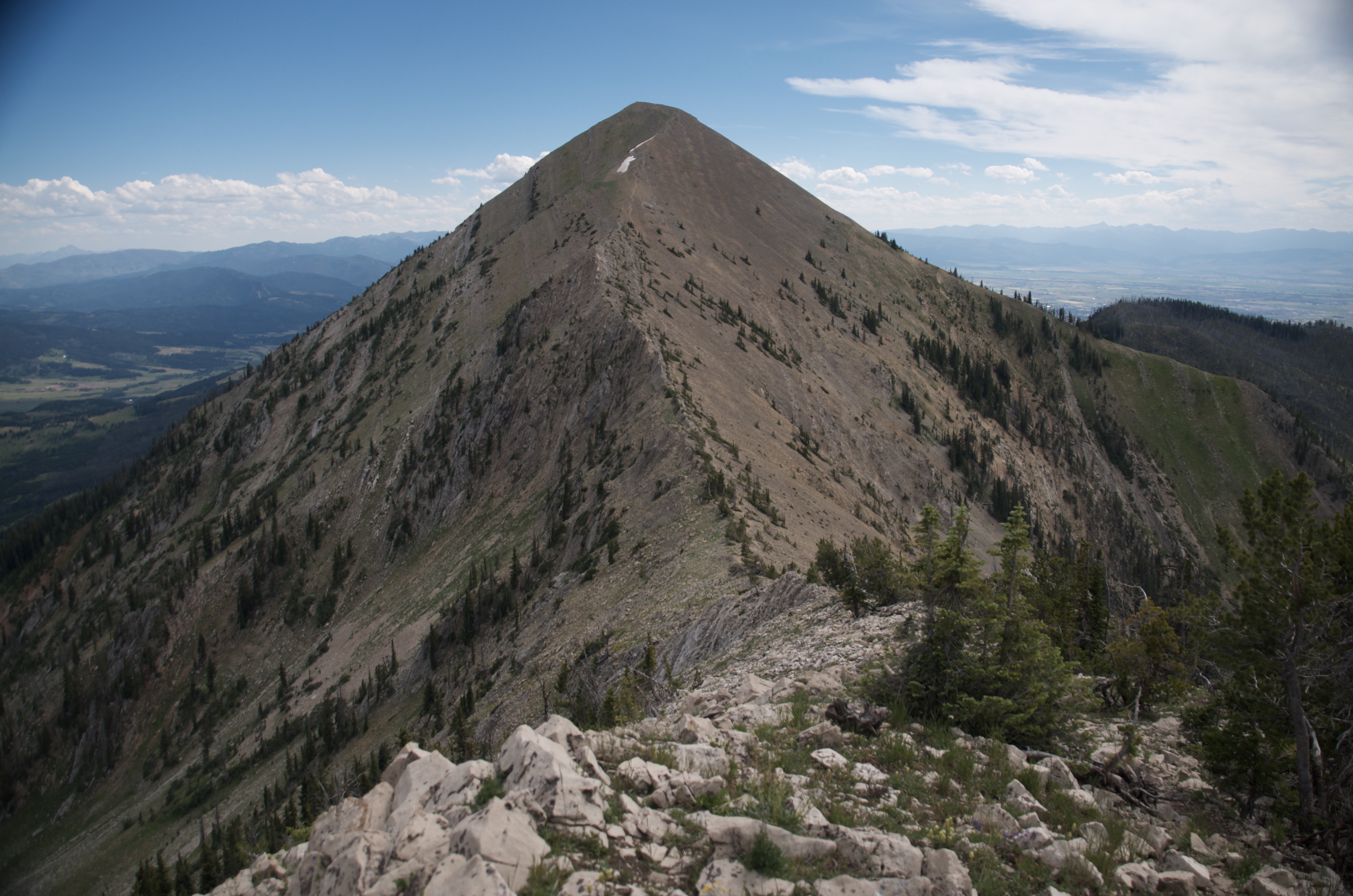 Sharp conical Bridger peak viewed along the rocky ridgeline with Bridger Canyon and Gallatin Valley visible on both sides