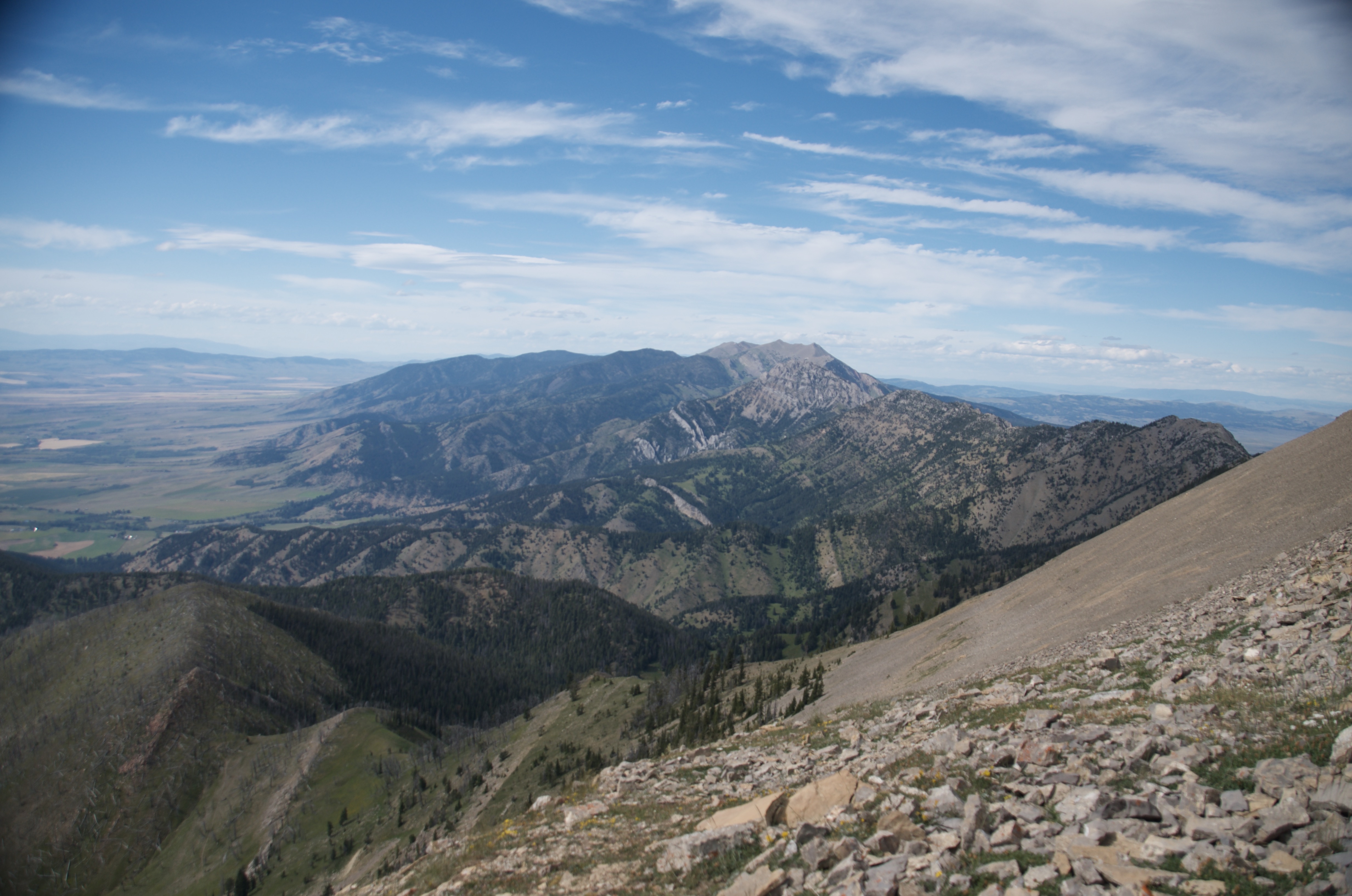Multi-peak Bridger Ridge view looking south with rocky foreground and Gallatin Valley stretching to the horizon