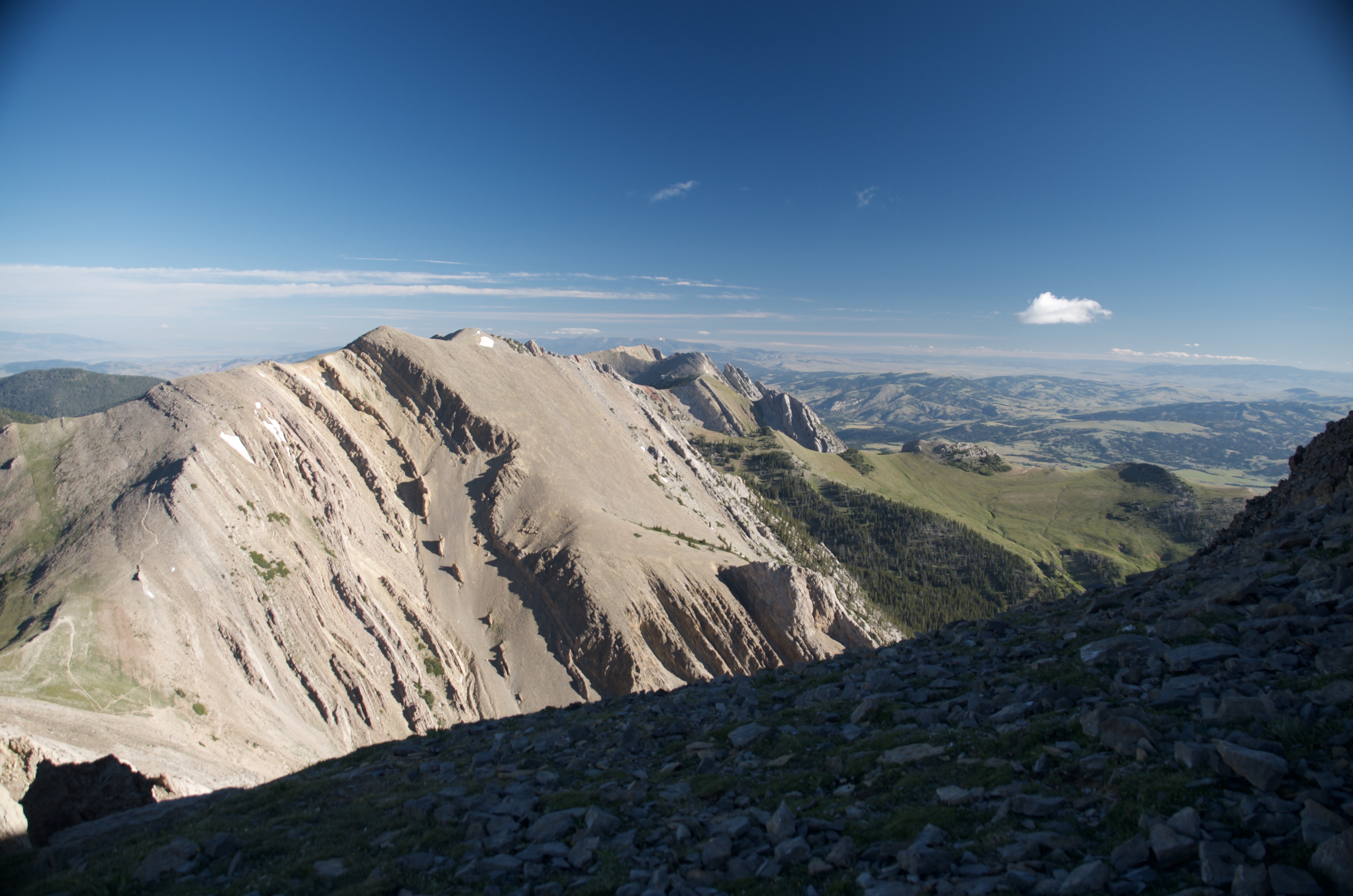 Broad striated limestone peak along the Bridger Ridge with Gallatin Valley visible to the right and Bridger Canyon dropping off to the left
