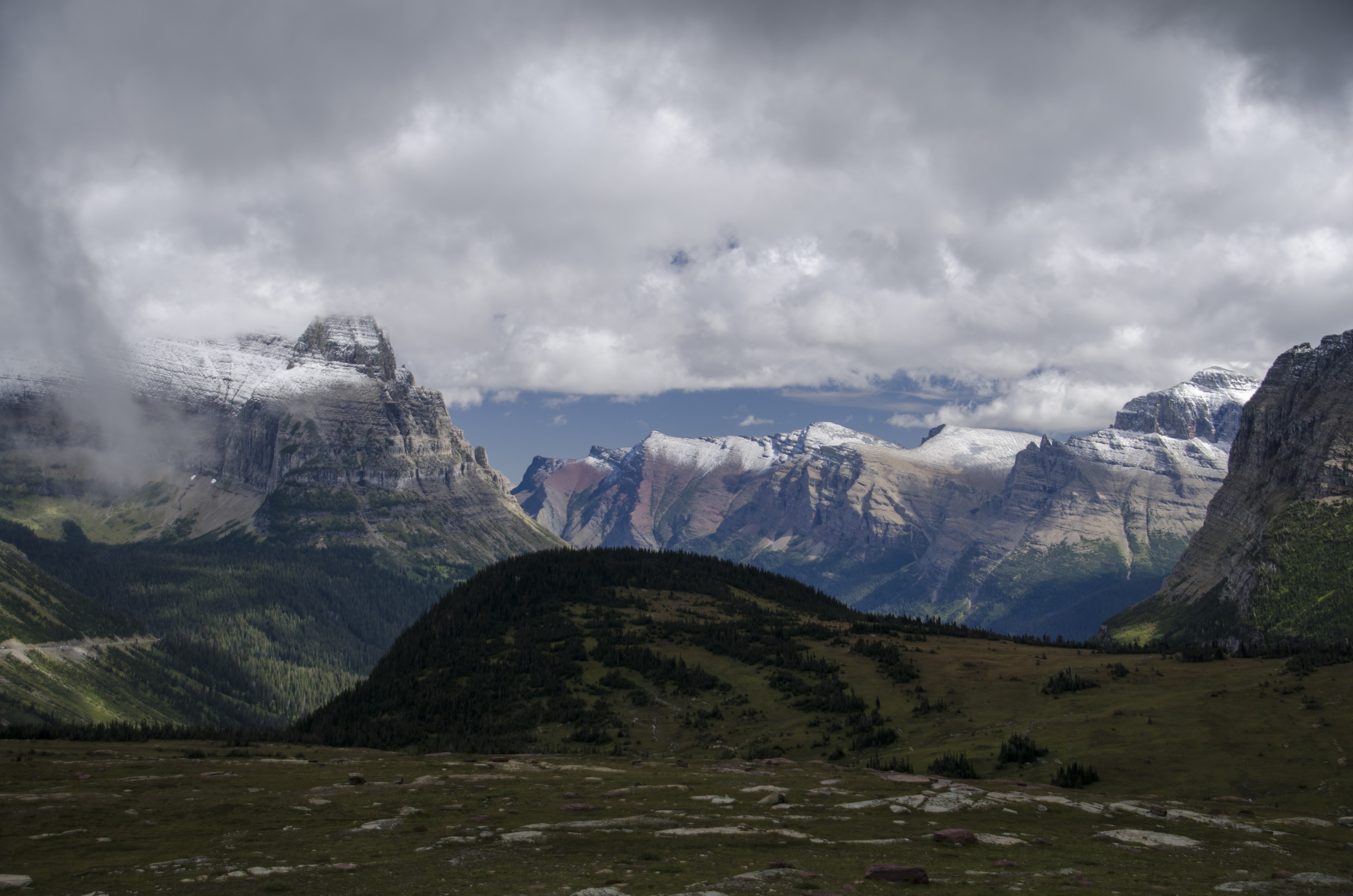 Mountain panorama with jagged peaks and green valleys from Logan Pass area