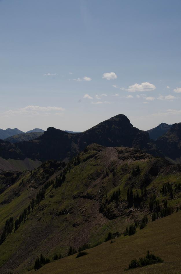 Rugged Hyalite peaks with steep grassy slopes and rocky summits