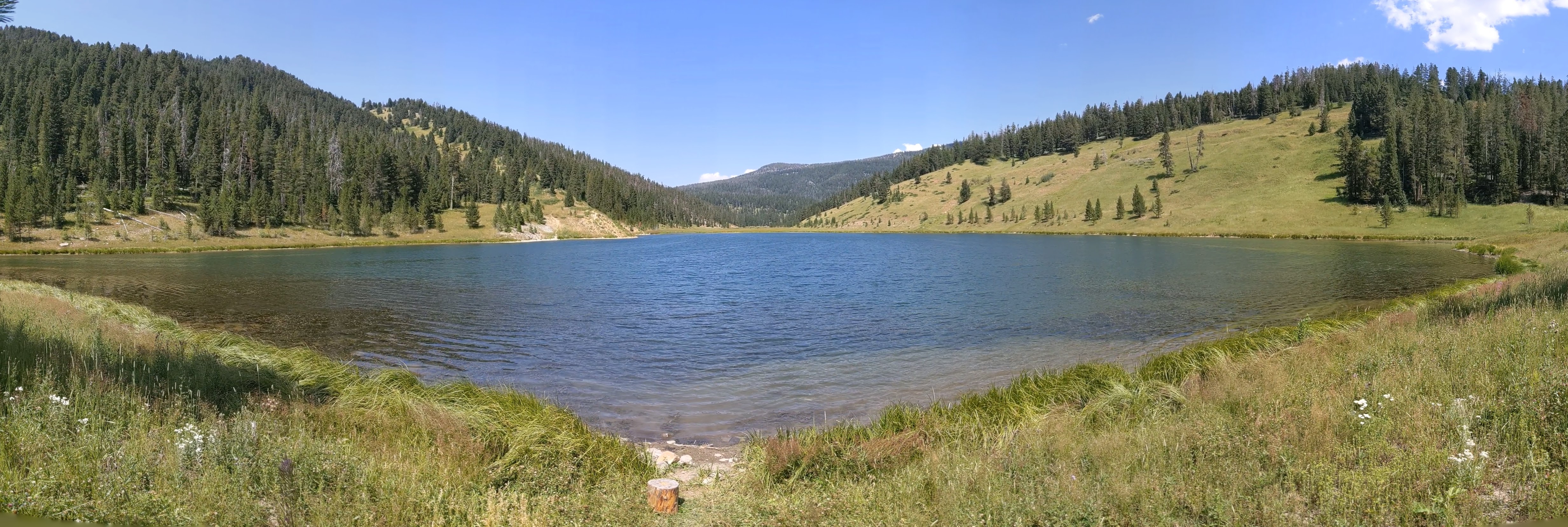 Panoramic view of Mystic Lake surrounded by forested hills