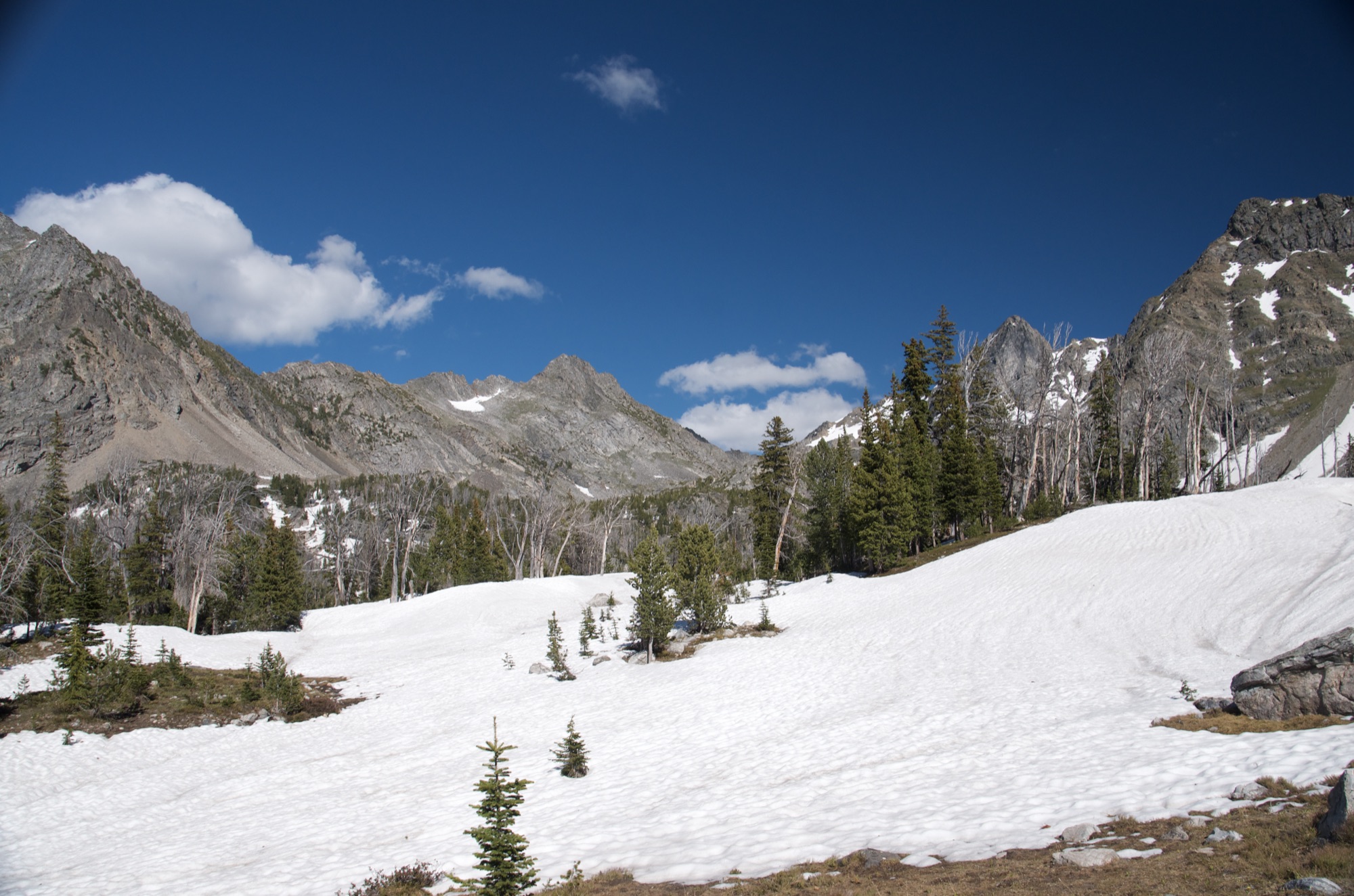 Snow-covered high basin with jagged Spanish Peaks rising in the background