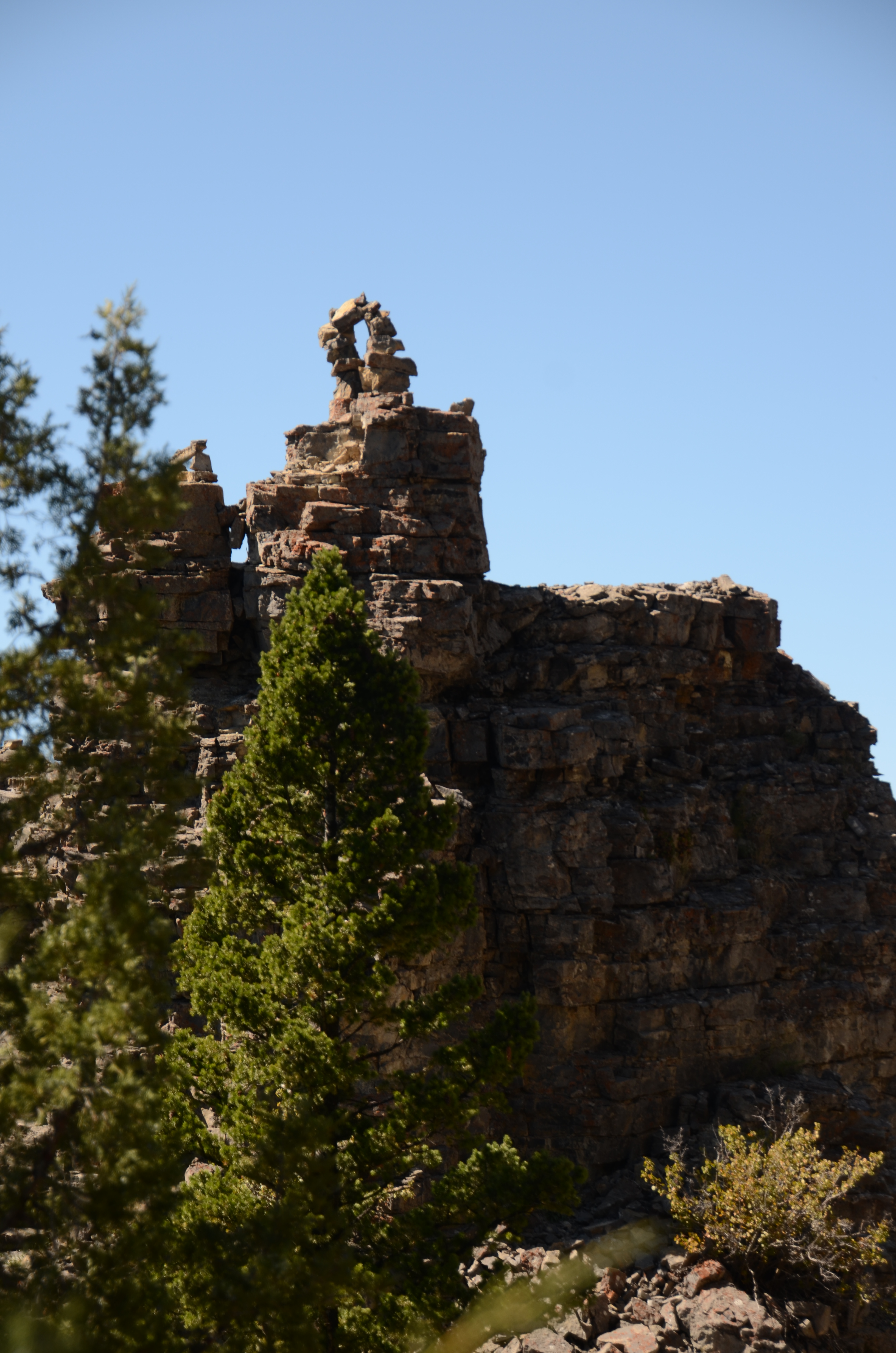 Storm Castle Peak limestone turret with the natural arch visible on top against a clear blue sky