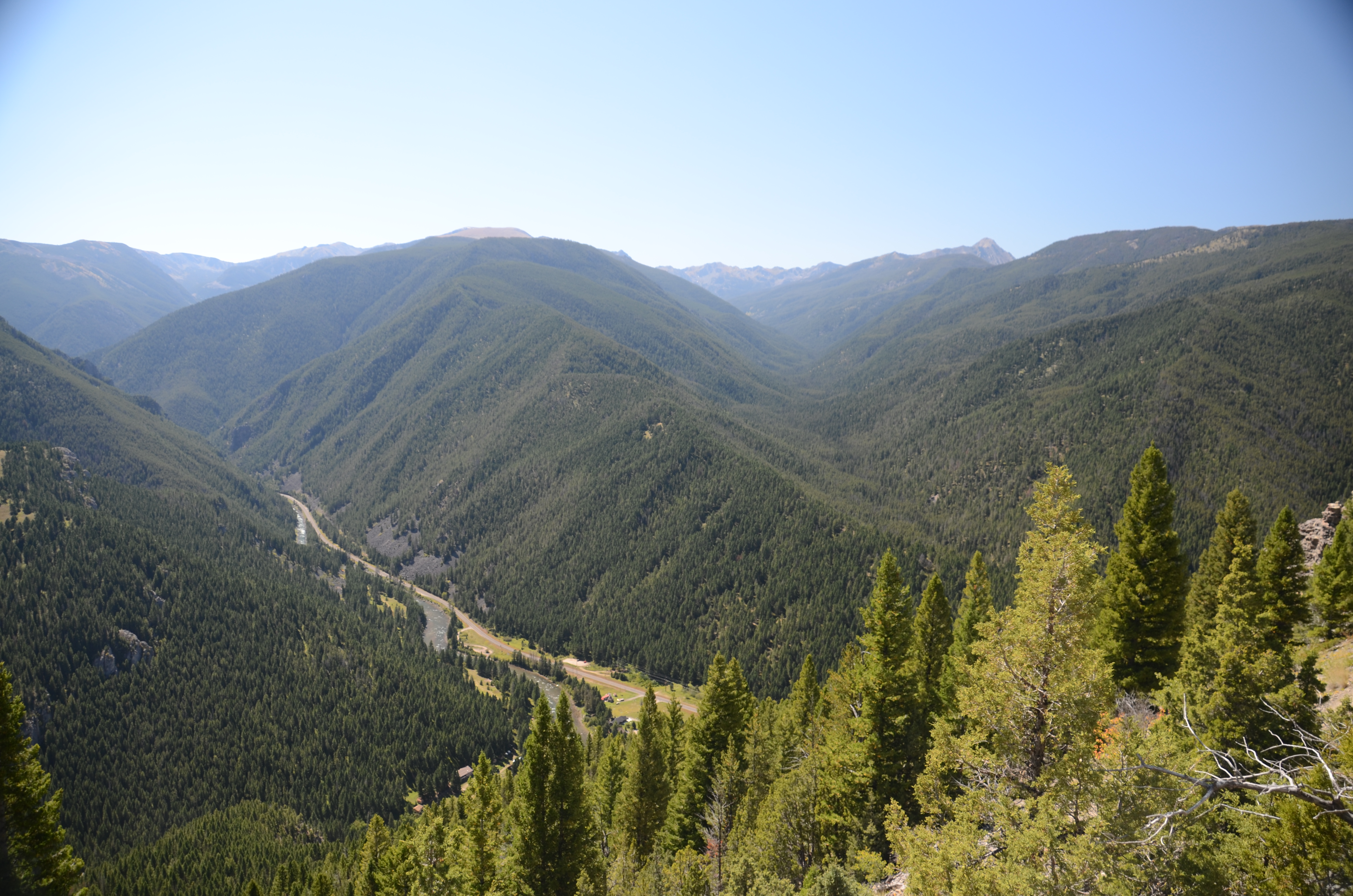 Wide panoramic view of the full Gallatin Canyon from high on Storm Castle Peak with the river winding far below
